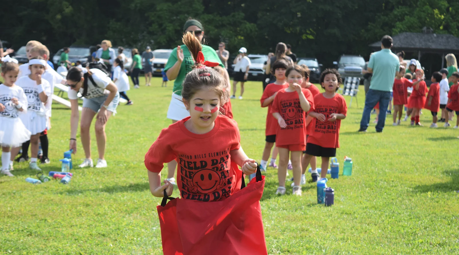 student jumps in potato sack in the field