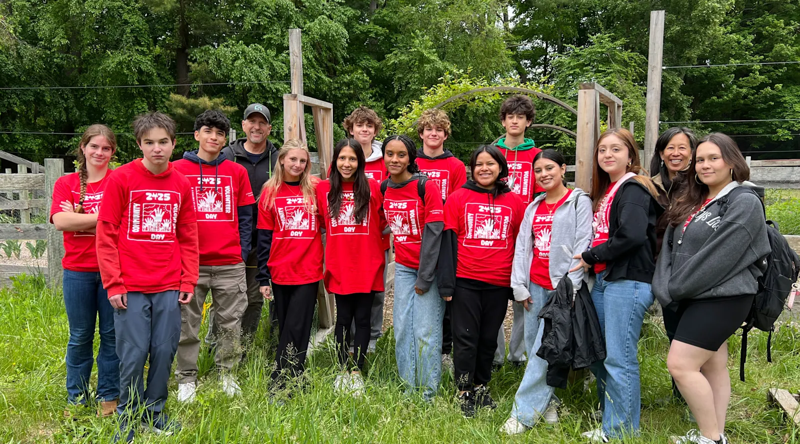 a group of students in matching t-shirts pose on Community Volunteer Day